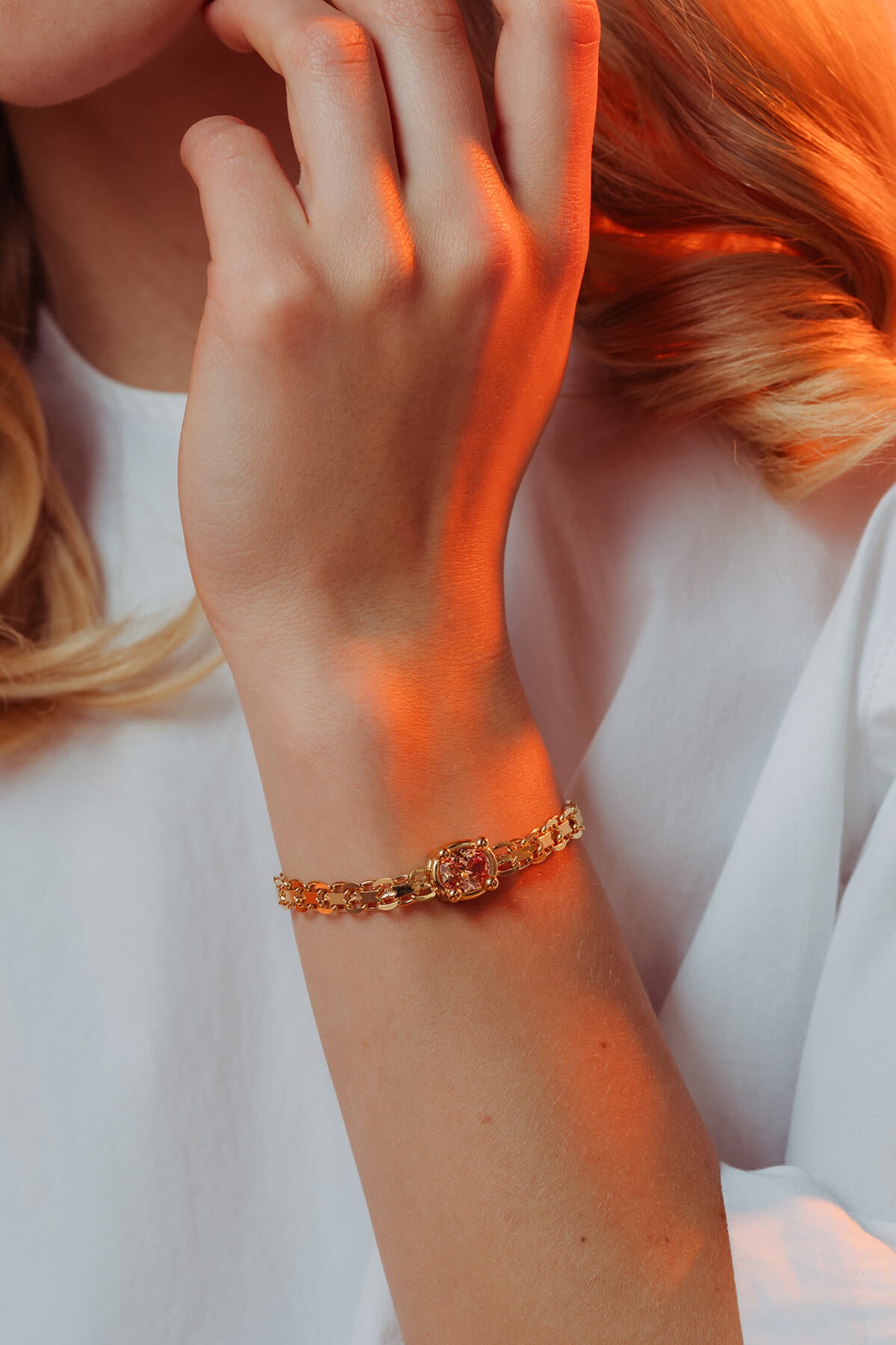 Drip T-lock bracelet with cubic zirconia featuring an oval orange cubic zirconia in a four-prong setting worn on the wrist.