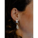 These earrings feature a gently curved element that elegantly hugs the earlobe.