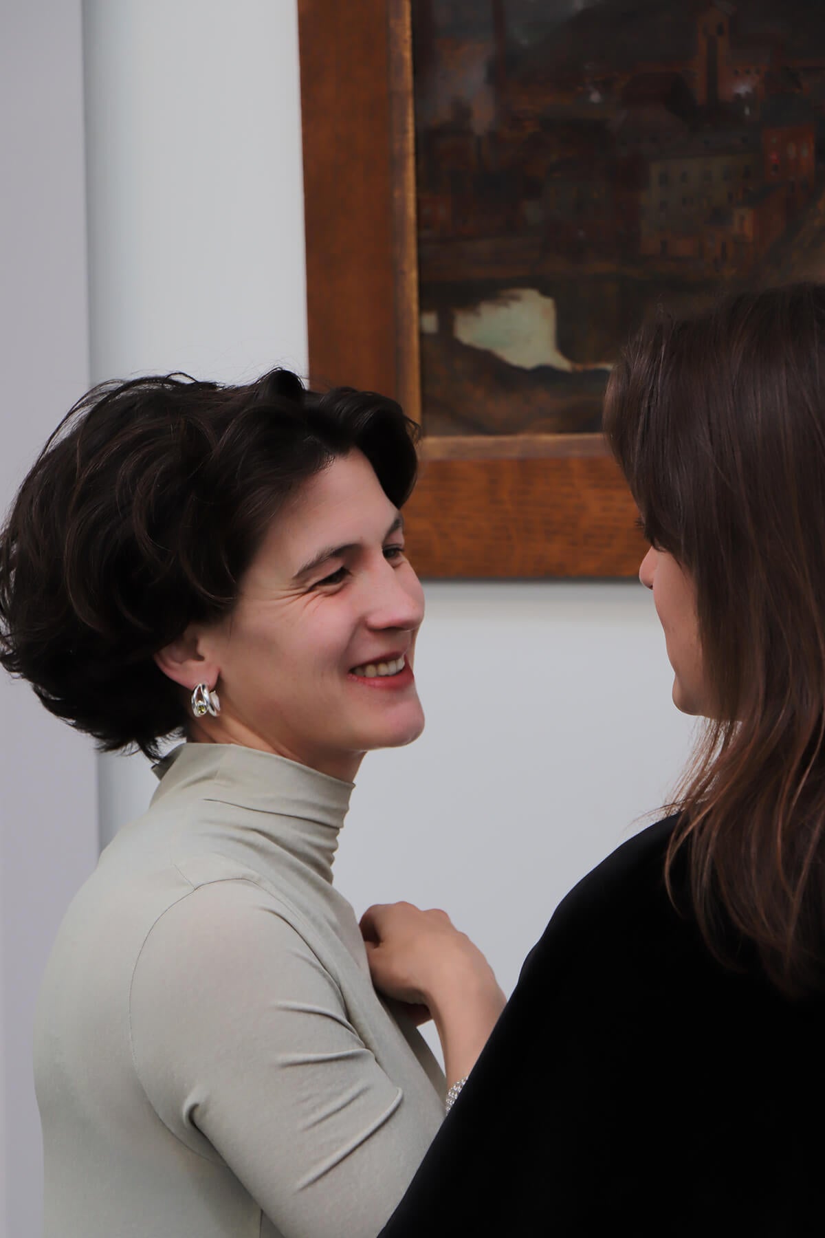 Hannah wearing Drop hoops smiling in conversation at La Piscine Musée Roubaix.