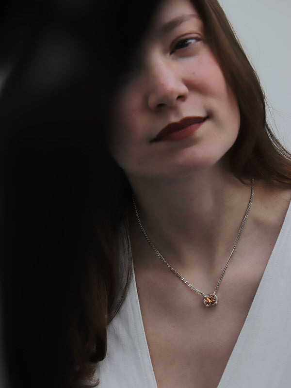 Magaly wearing Drip necklace with oval-cut orange cubic zirconia at La Piscine Musée Roubaix.