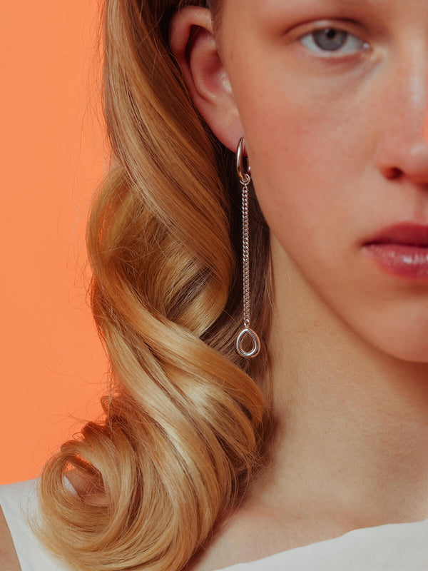 Splash earrings in silver featuring a detachable fine chain and drop pendant hanging from a droplet-shaped hoop.