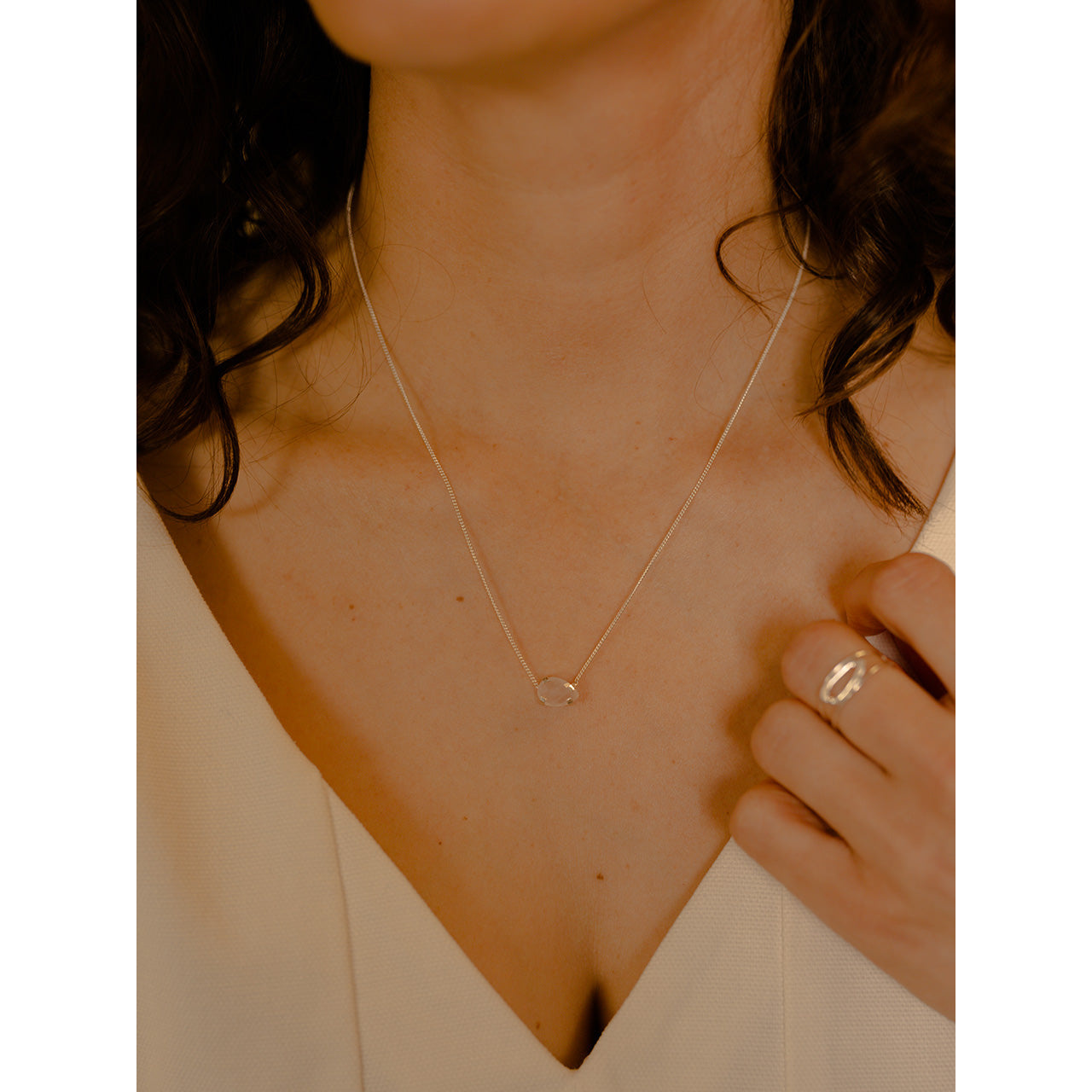 This delicately crafted necklace features a drop-shaped pink quartz stone held securely by a four-prong setting.
