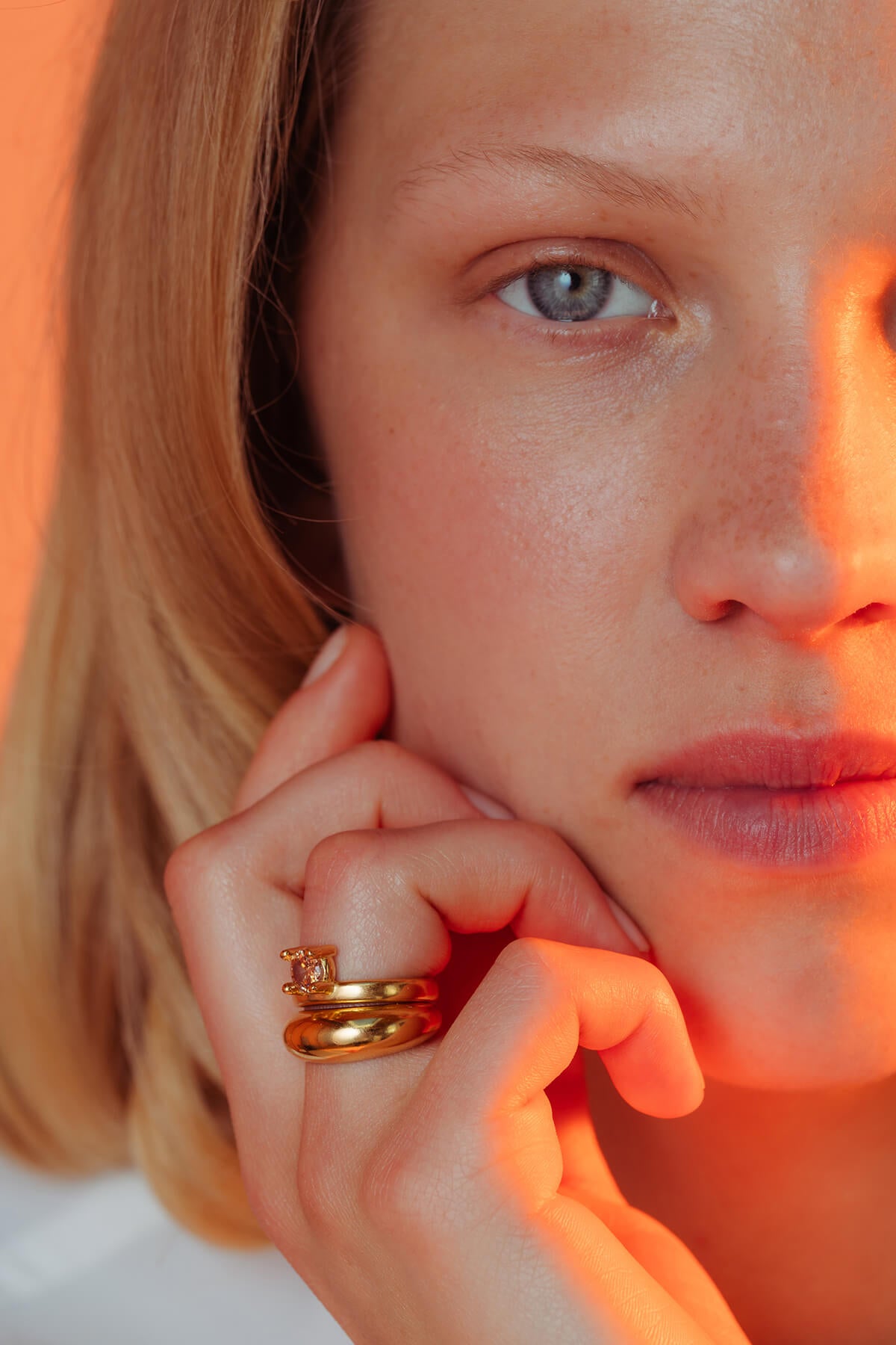 Drip ring with cubic zirconia featuring two stackable gold-plated rings with a round orange cubic zirconia.