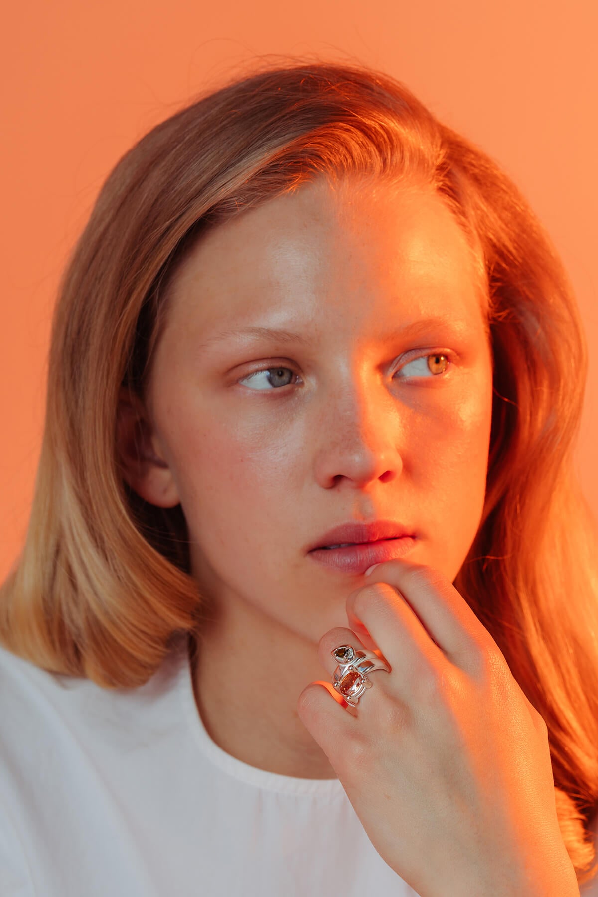 Drip ring with cubic zirconia featuring green pear-shaped and orange oval cubic zirconia on a sculptural silver ring.