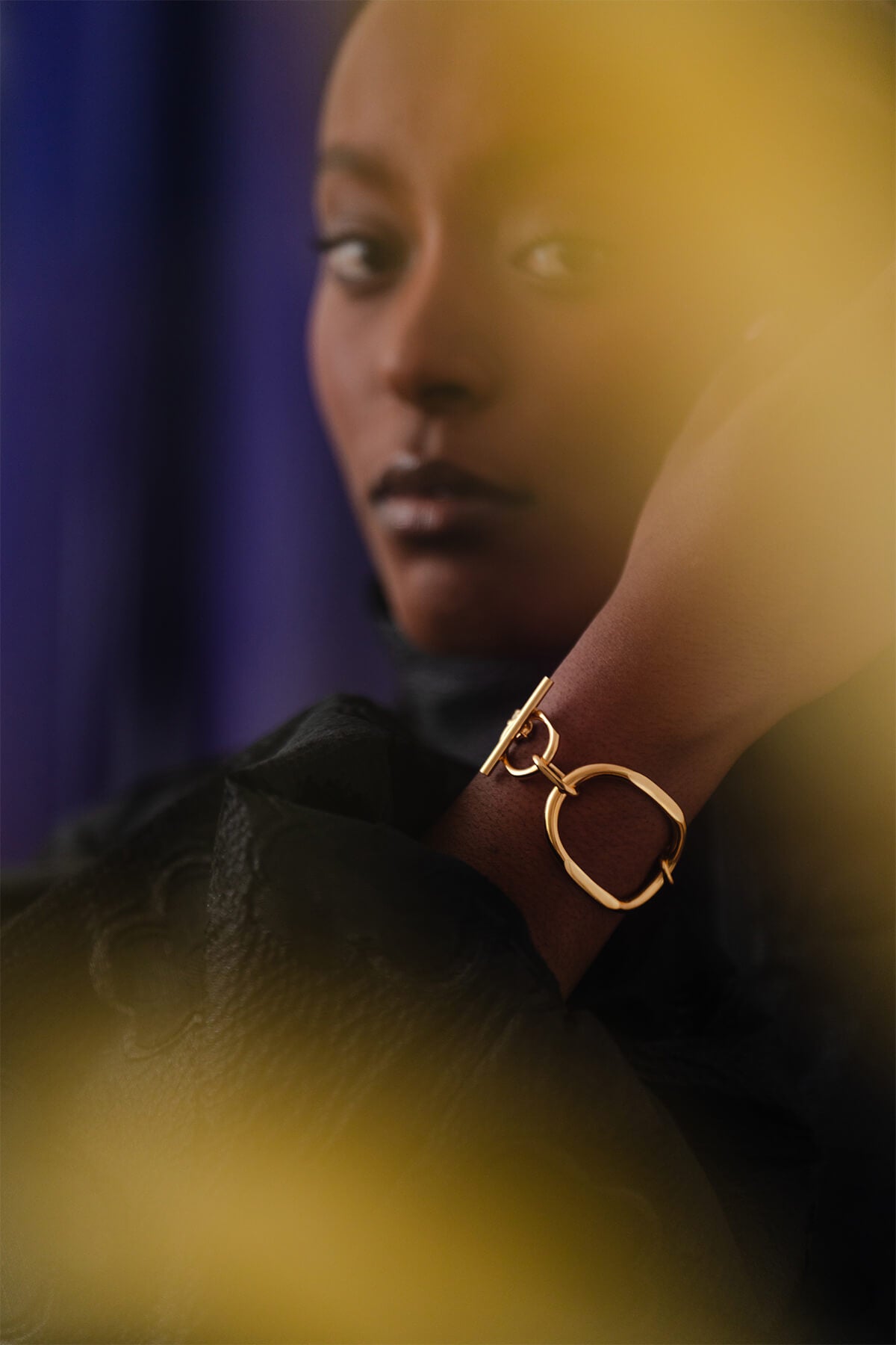 Meseret wearing the bold Facet Bracelet - a sculptural statement piece with round, faceted links and a distinctive T-lock closure.