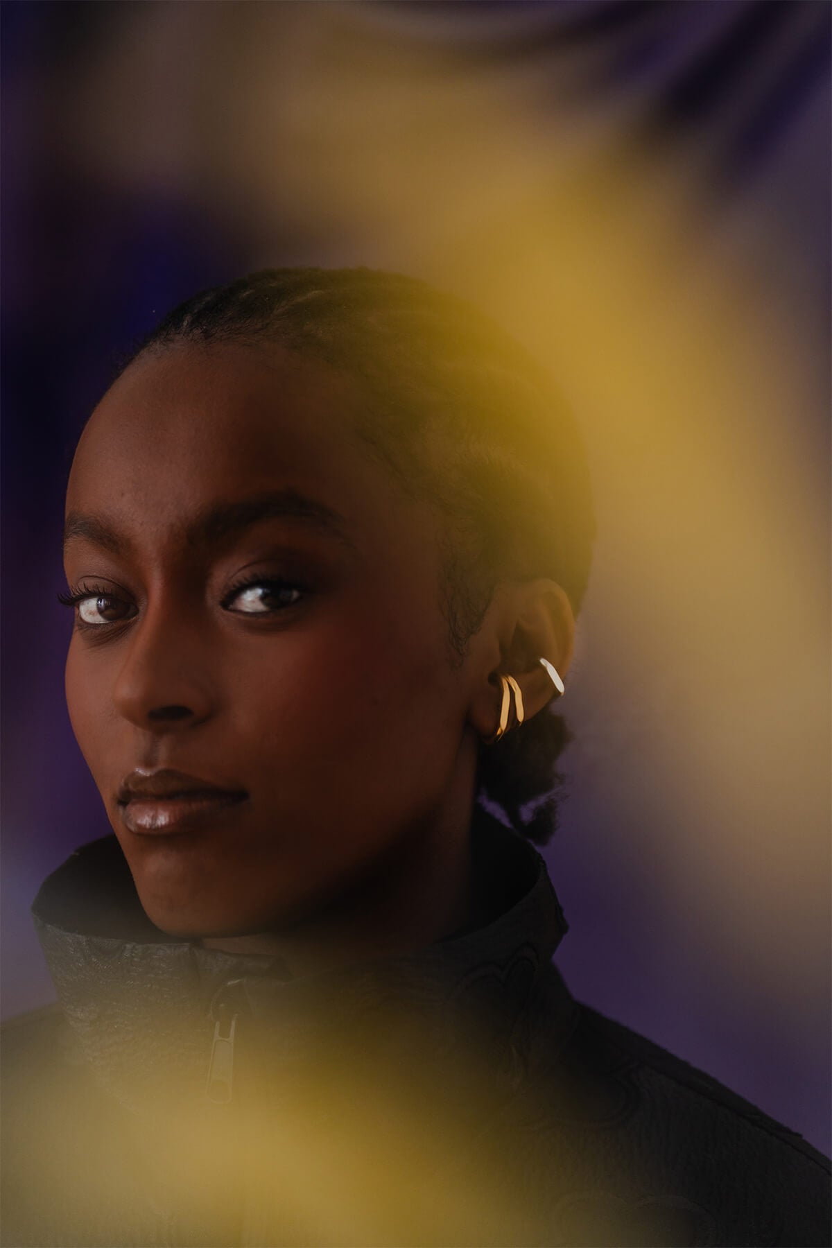 Modern oval hoop earrings with sculptural form and crisp facet detailing, designed to hug the earlobe comfortably.