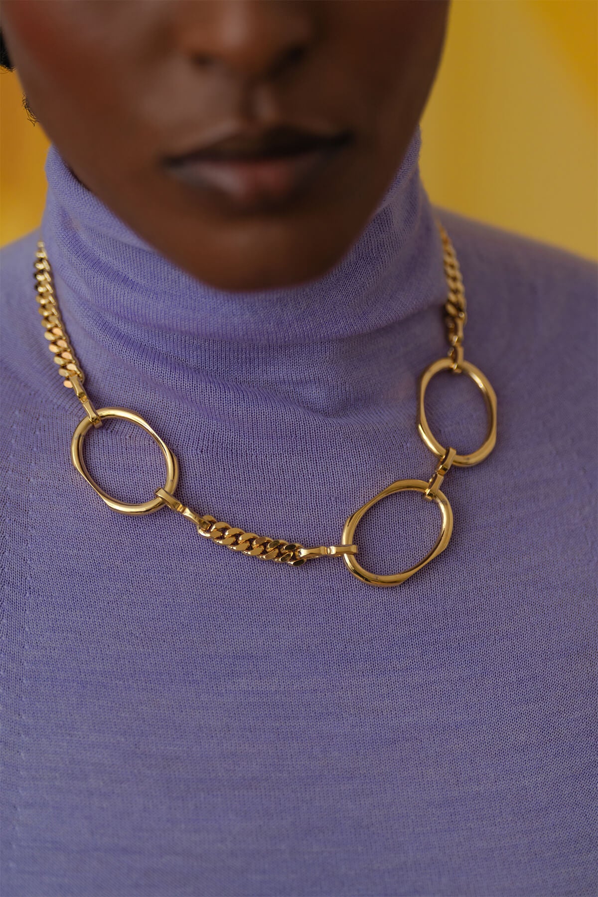 Meseret styles the Facet Necklace - a confident, refined statement chain necklace with geometric detailing and a polished modern design.