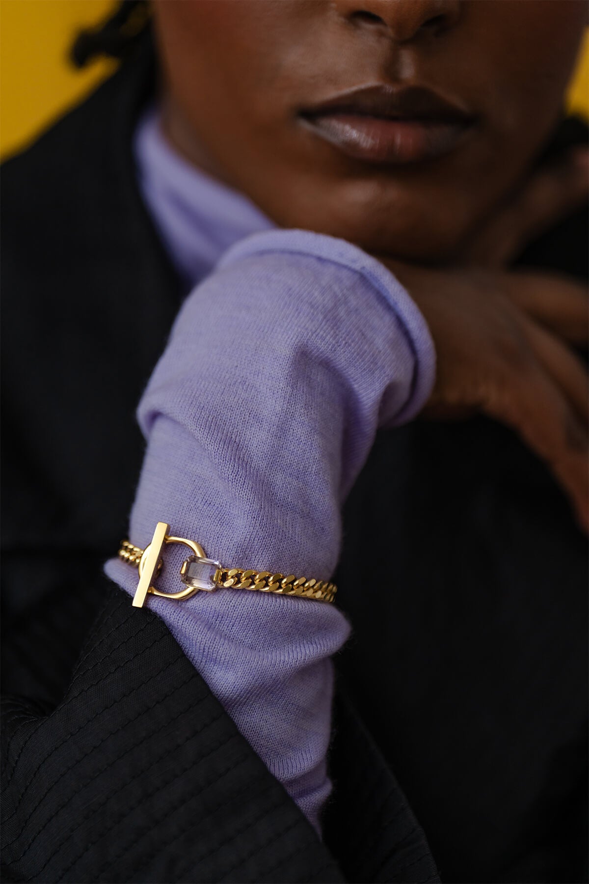 Modern statement bracelet featuring a thick gourmet chain, geometric T-bar lock, and an emerald-cut ametrine for a subtle touch of color.