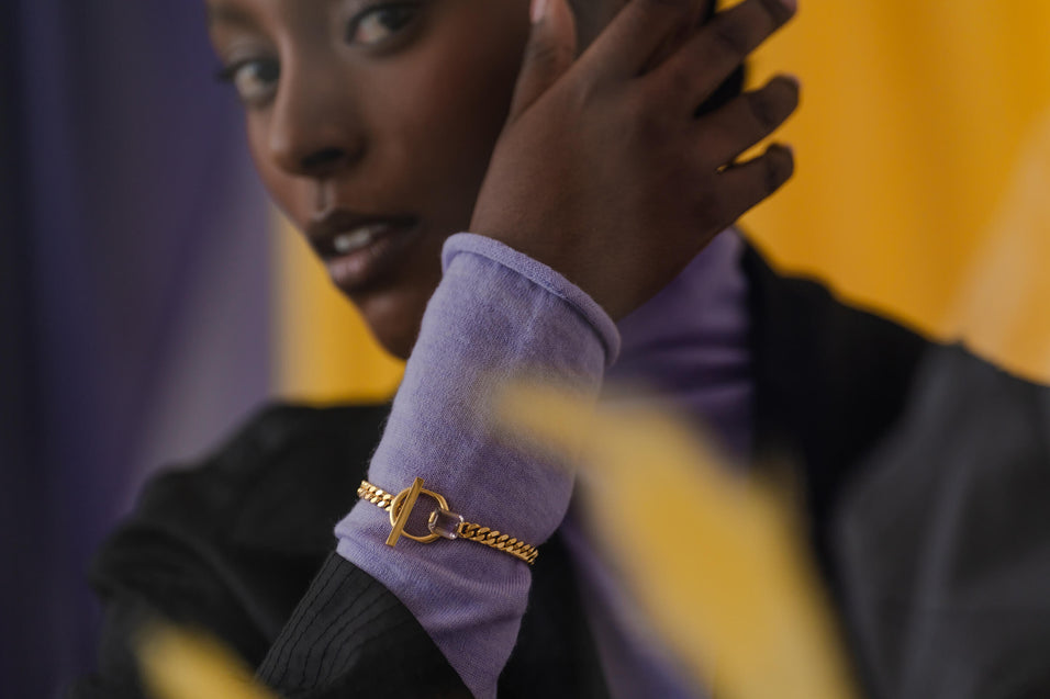 Meseret wearing the Prism Bracelet, a bold chunky chain bracelet with an emerald-cut ametrine and O-shaped T-lock closure.