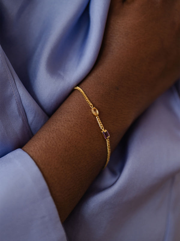 Meseret wearing the Ray Bracelet, a delicate gourmet chain with amethyst, citrine, and a tiny freshwater pearl for everyday.
