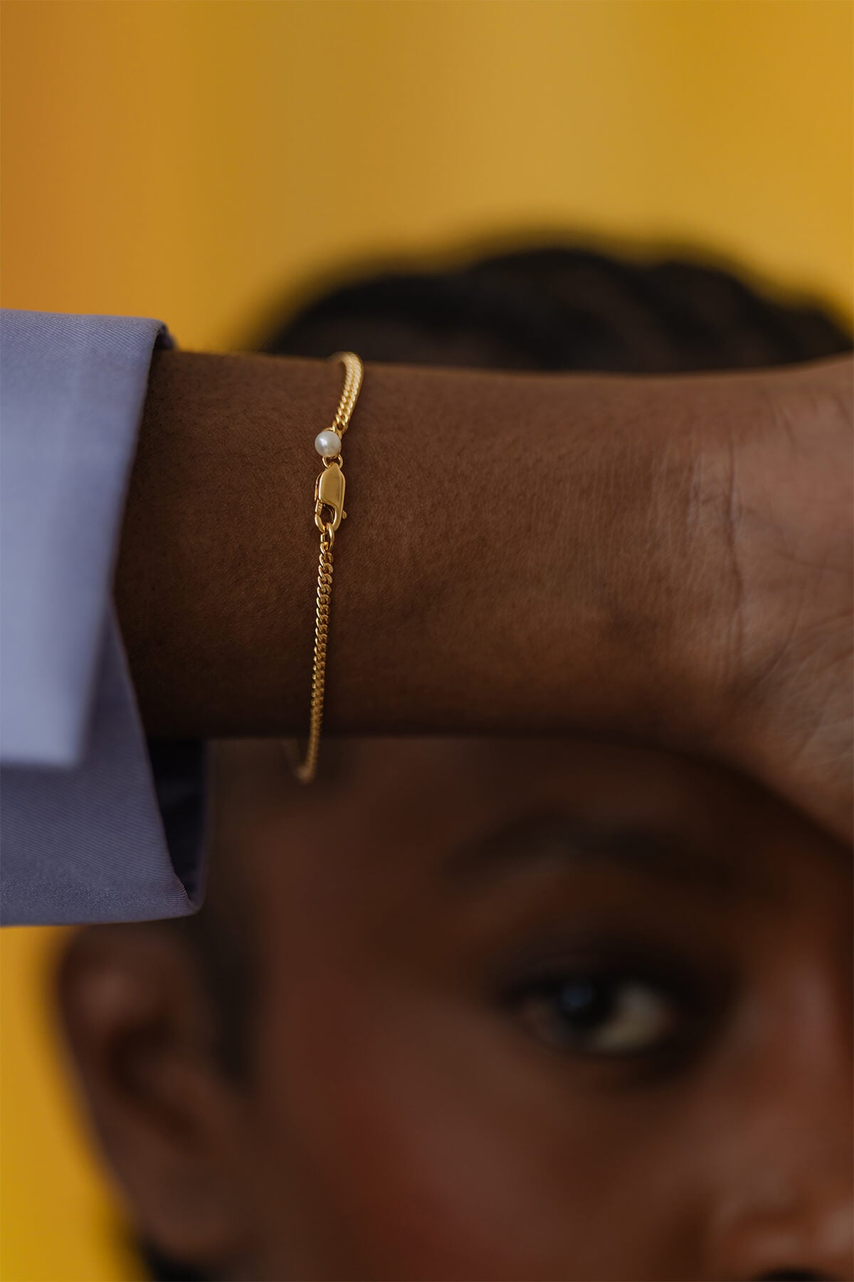 Detail of Ray Bracelet featuring an emerald-cut amethyst, oval citrine, and pearl detail near the clasp.