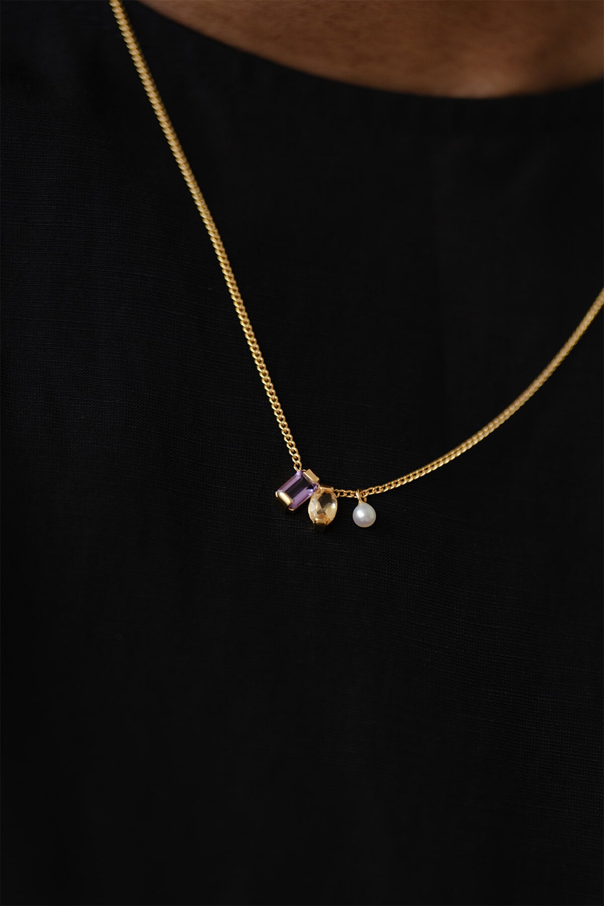 Close-up of the Ray Necklace with amethyst, citrine, and pearl, adding a soft touch of color and sophistication.
