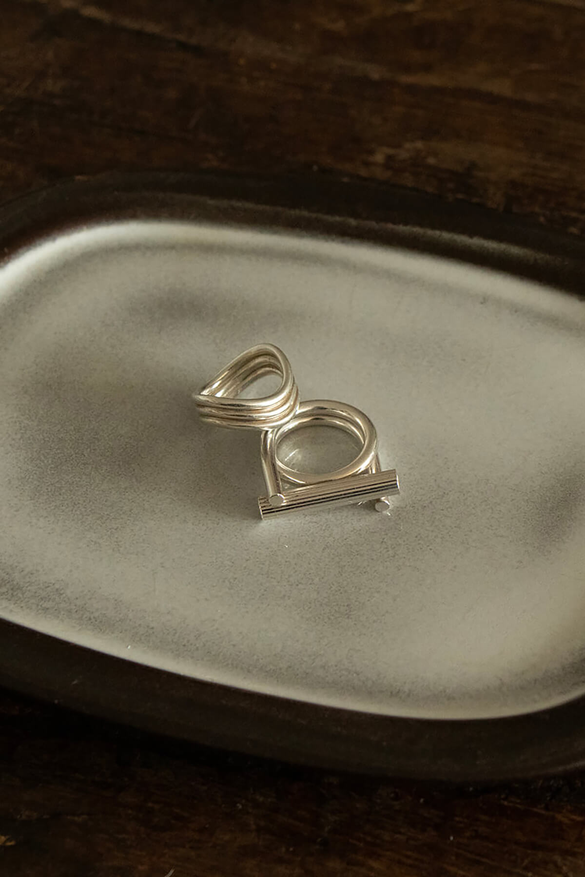 Studio Collect silver Carve Ring presented on a ceramic tray.